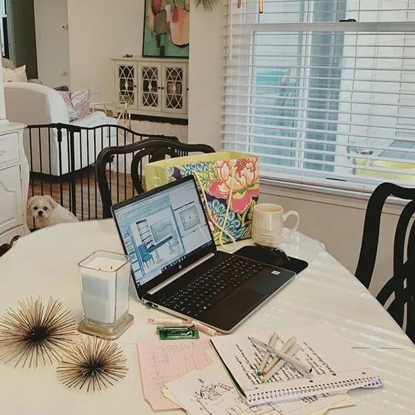 laptop and notebook on a kitchen table
