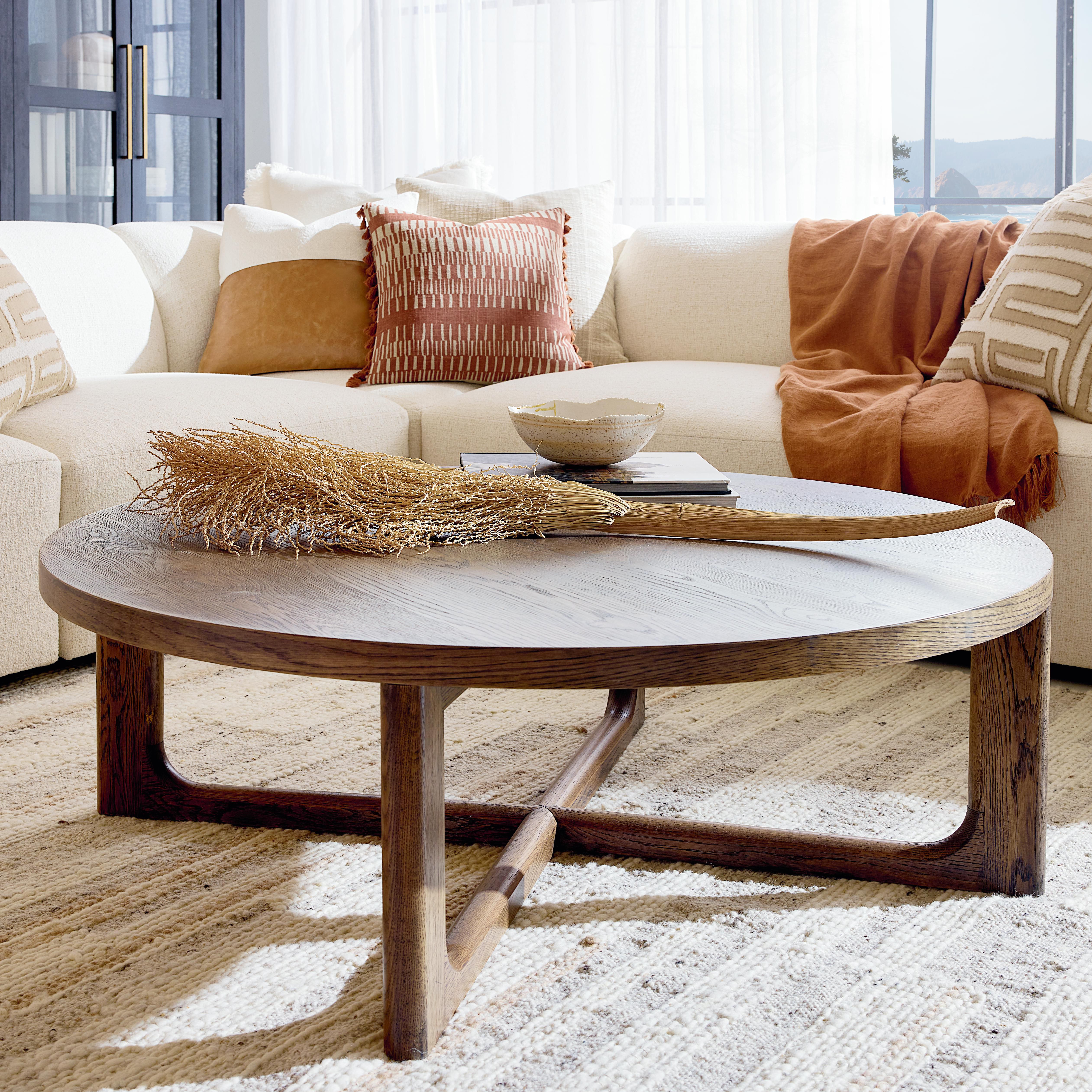 Wood cocktail table in front of beige sofa