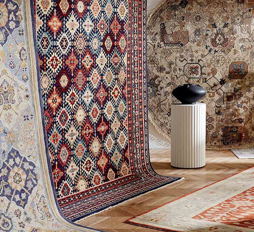 Display of rugs hanging from the wall