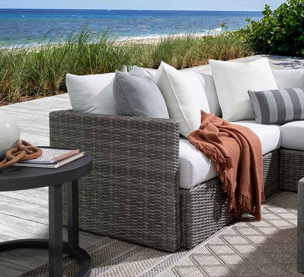 Outdoor furniture on patio overlooking ocean
