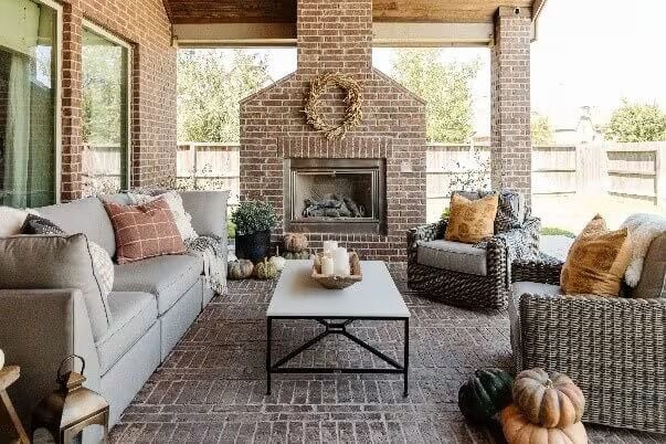 brick patio with fireplace and furniture