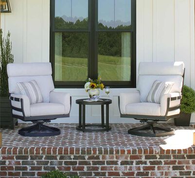 Outdoor swivel chairs on a  brick porch