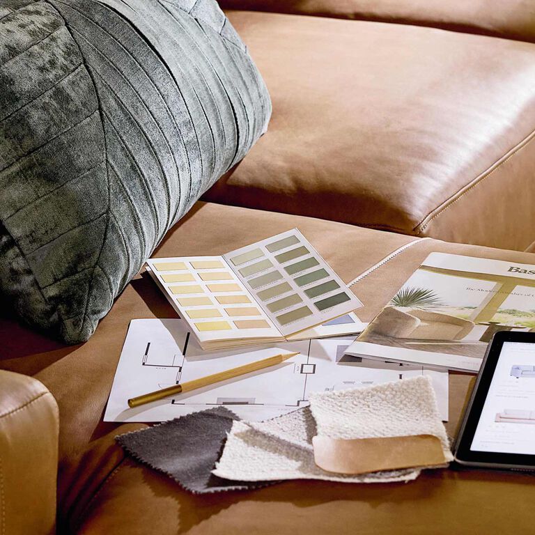 Interior designer resources on a rich brown leather sofa