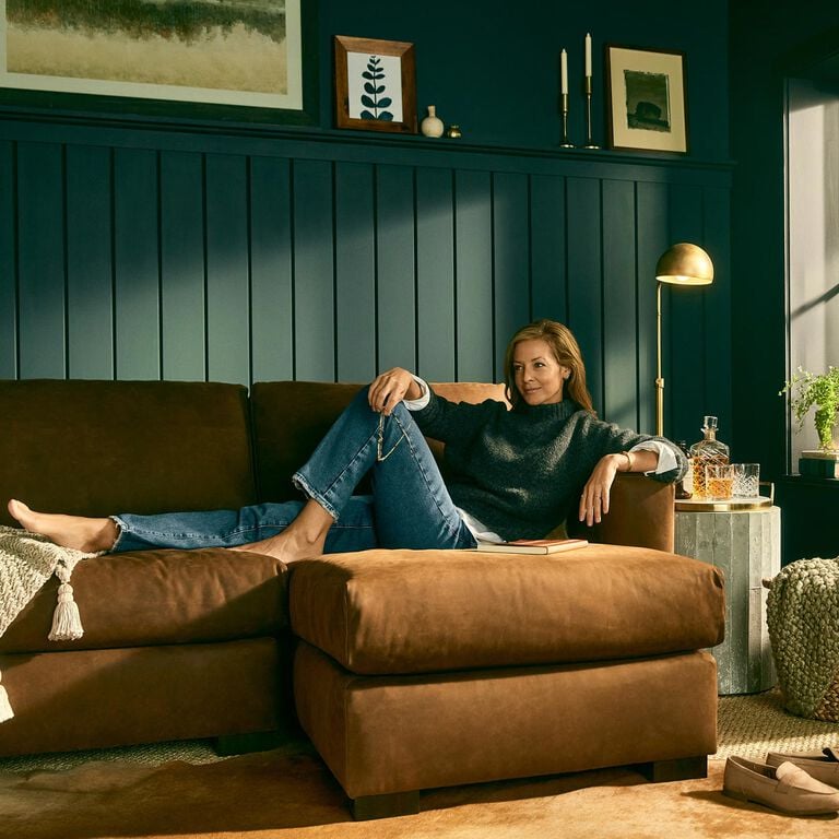 Woman sitting comfortably on Weldon leather sofa