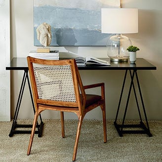 Desk with Keller chair against wall with painting