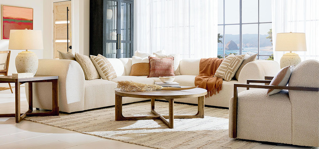 White sectional sofa with wood coffee & accent tables