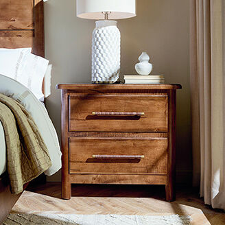 Wood nightstand with lamp and decor on top
