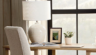 Beige and white lamp on a wooden desk