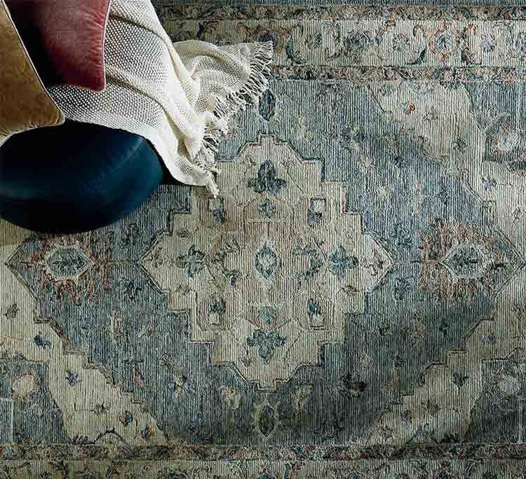 Rug with upholstered ottoman on top