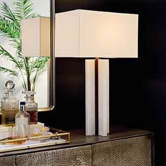 Lamp on crendenza with mirror on wall in background