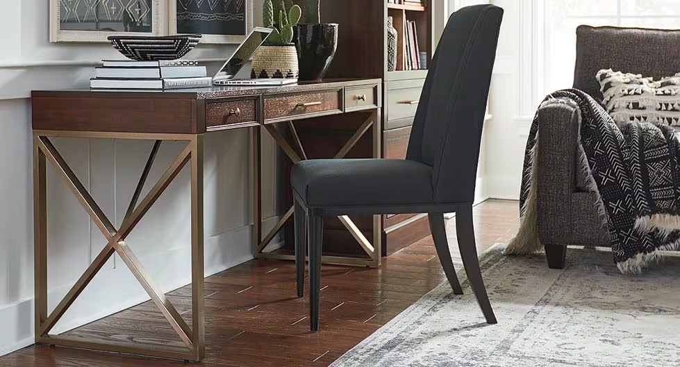 Narrow desk placed against wall with armless desk chair